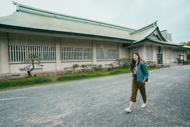 Woman backpacker walking in front ground