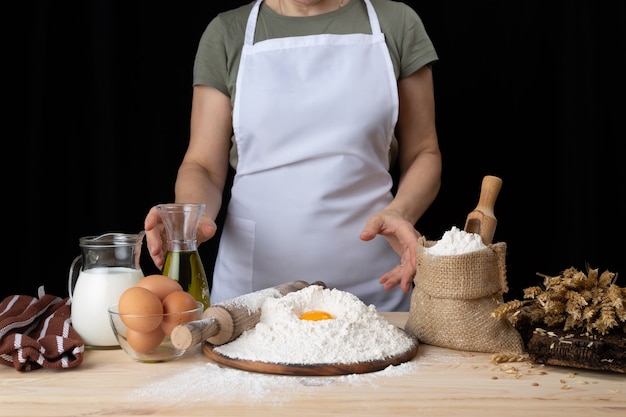 Woman baker prepares pastries with recipe