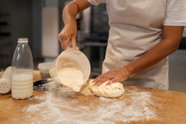 Woman baking in kitchen side view