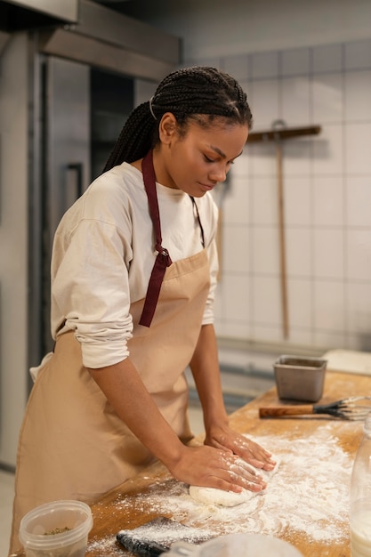 Woman baking in kitchen side view