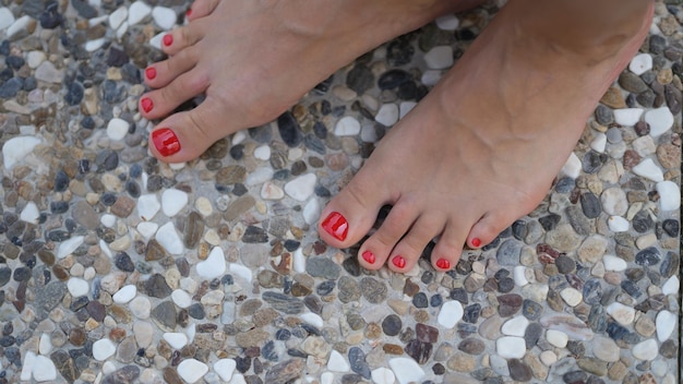 Woman bare feet stand on stone tile floor