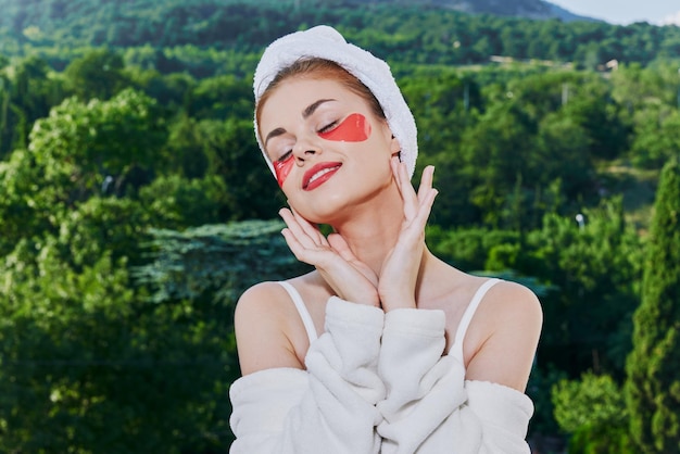 Woman in a bathrobe in a white robe the balcony overlooks the mountains unaltered