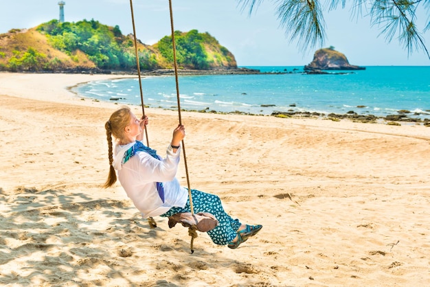 Woman on beach swing