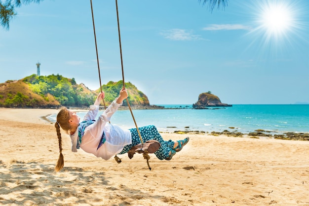 Woman on beach swing