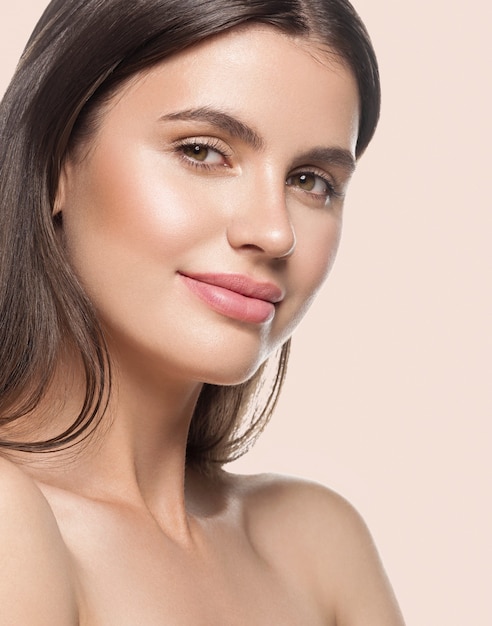 Woman beauty face healthy clean skin natural makeup beauty eyes female young model Beige background.