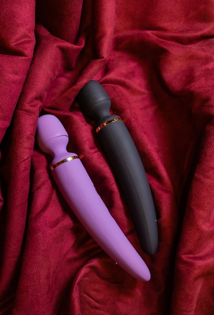 Woman in bedroom holding vibrator in hand