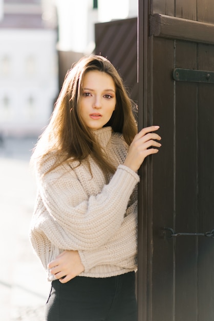 A woman in a beige sweater