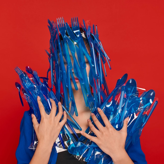 Woman being covered in plastic tableware