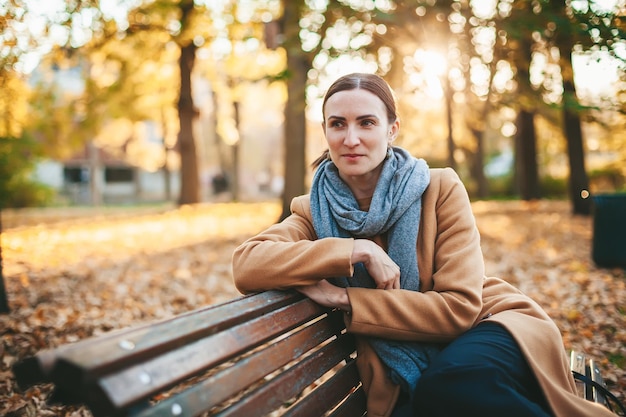 Woman on the bench in the autumn park