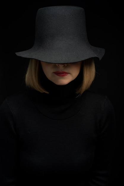 Woman in black dress and black hat