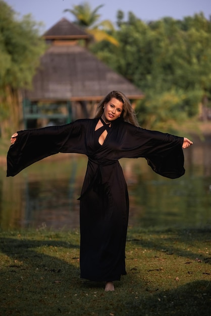 Woman in a black dress with a black bow