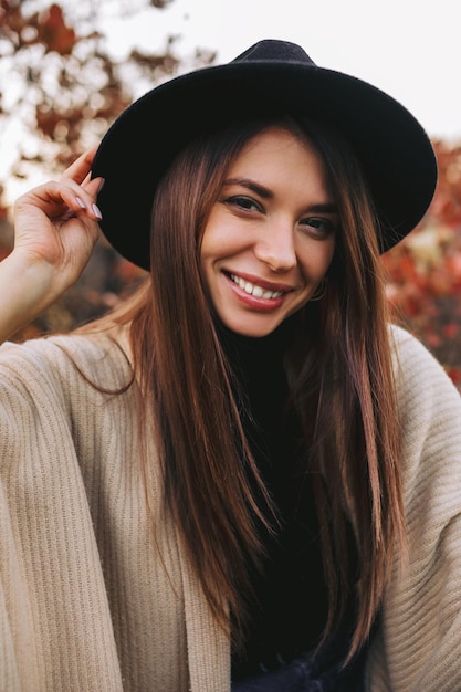 Woman in black hat outdoors in autumn