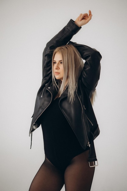 A woman in a black leather jacket with the word love on it