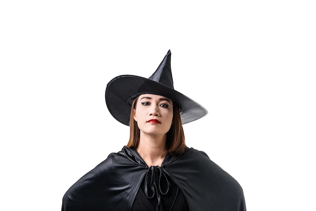 woman in black Scary witch halloween costume standing with hat isolated white 