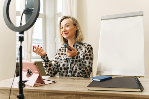 Woman blogger or coach during online broadcast at home