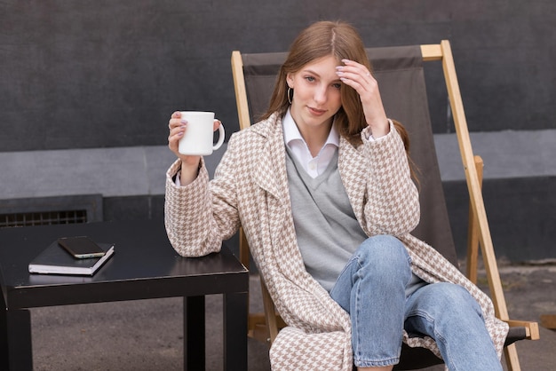 Woman blogger with coffee outside rest content