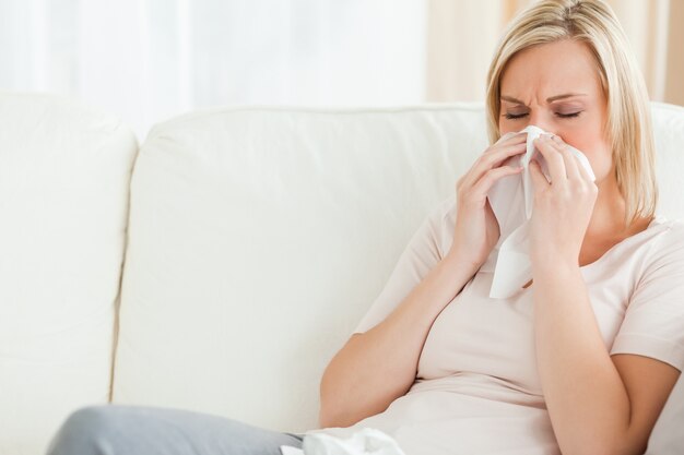 Woman blowing her nose