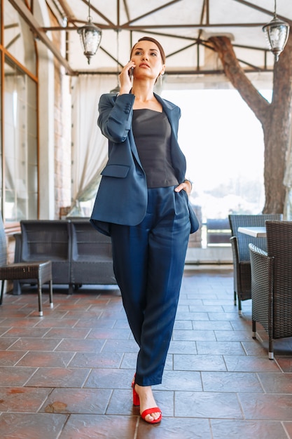 Woman in a blue business suit in a coffee place