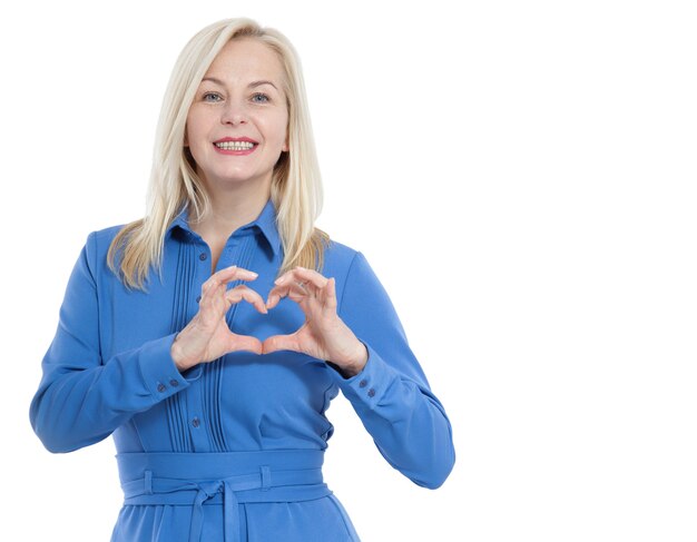 Woman in blue dress looks at the camera and shows a gesture I love you isolated on white.