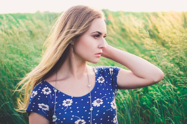 Woman in a blue dress with daisies