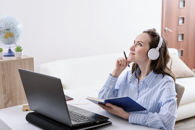 Woman in blue shirt listens to music