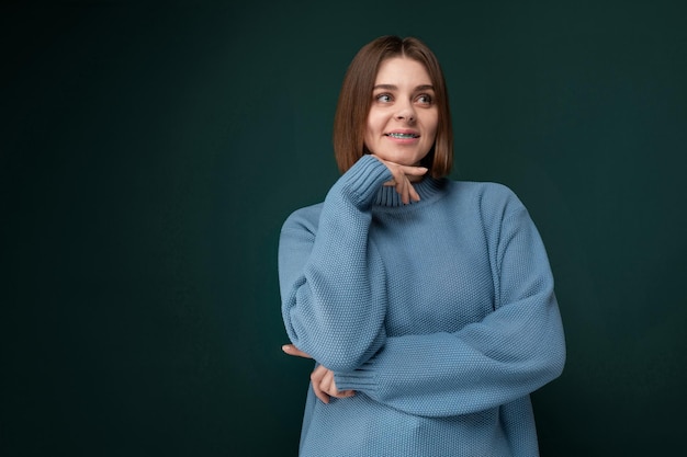 Woman in a blue sweater posing for a picture