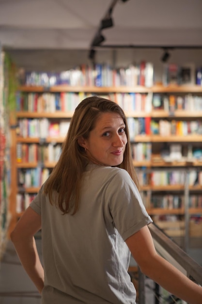 Woman In Bookstore Looking Over Shoulder