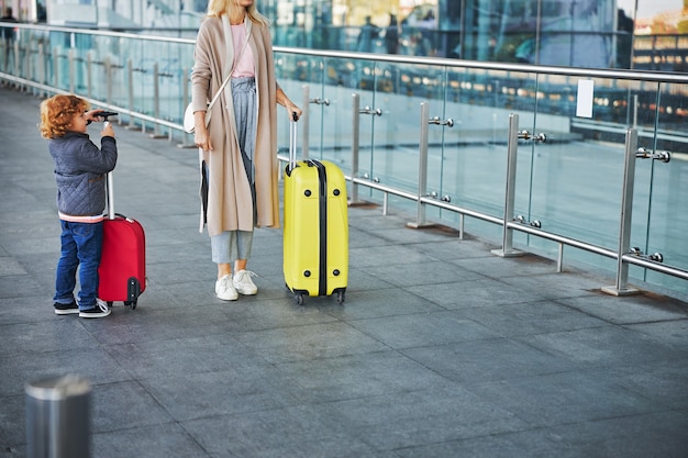 Woman and a boy standing with baggage