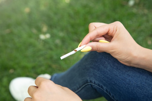 Woman breaking cigarette in outdoor