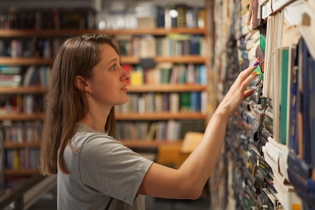 Woman Browsing Bookshelves in a Bookstore