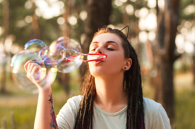 Woman bubble blowing hiker nature concept. Unity with the nature.