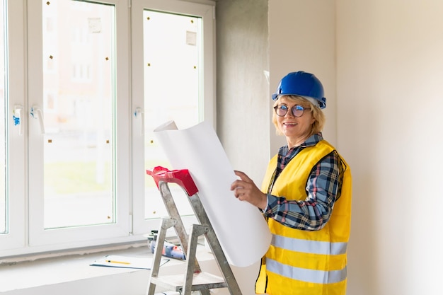 Woman Builder in the room of the house making repairs