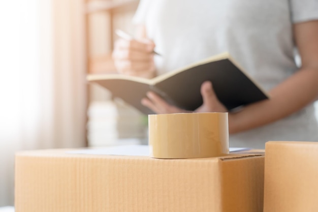 Woman business owner check the parcel before delivery process