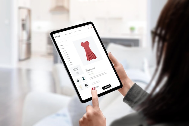 Woman buys a dress online with tablet concept Modern ecommerce clothing website Living room in background