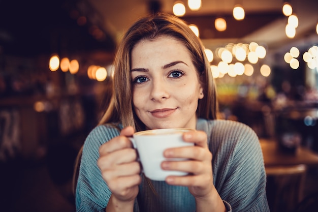 woman in a cafe drinking coffee