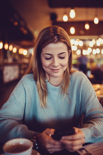 woman in a cafe drinking coffee