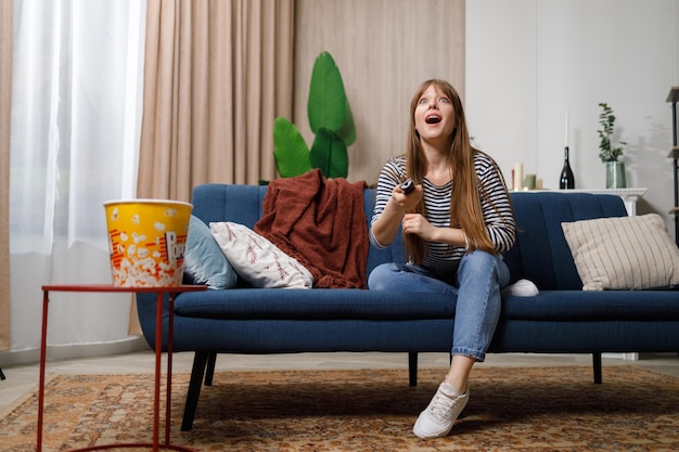 Woman cannot tear herself away from watching TV The girl is addicted to television