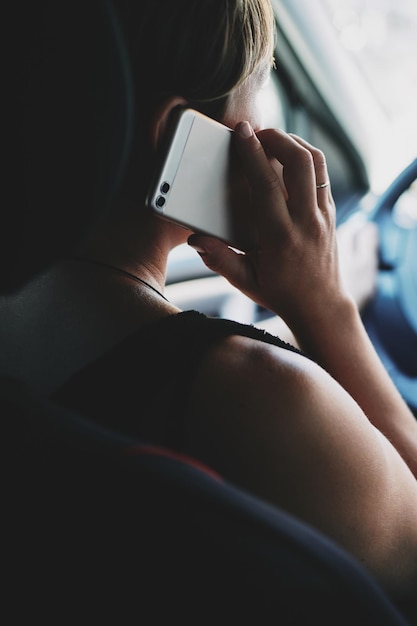 Woman in the car talking on mobile phone while driving