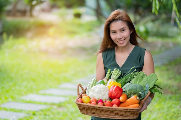 Woman carrying vegetables basket with blur background