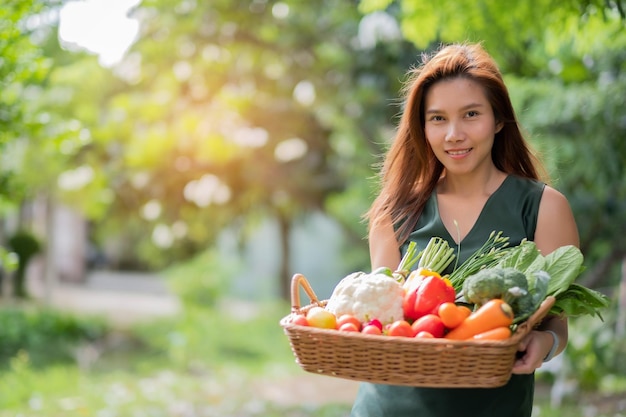 woman carrying vegetables basket with nature background