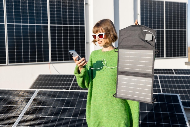 Woman charging phone from a solar portable panel