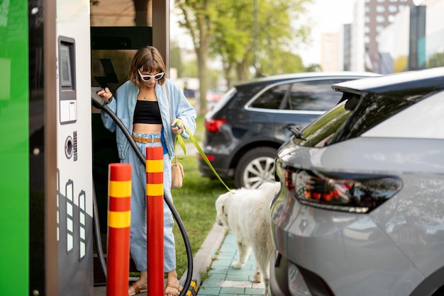 Woman on charging station for electric cars