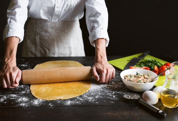 Woman chef cooks step by step the traditional ravioli