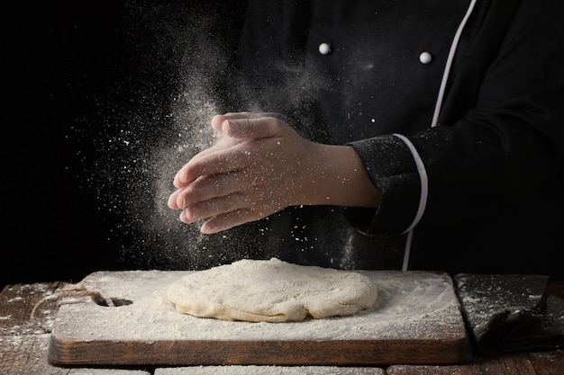 Woman chef hand clap with splash of white flour.