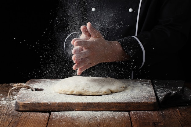 Woman chef hand clap with splash of white flour.