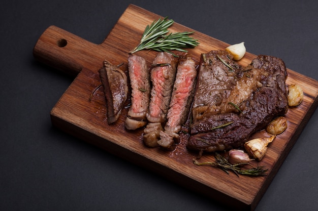 The woman chef is preparing a beef steak.