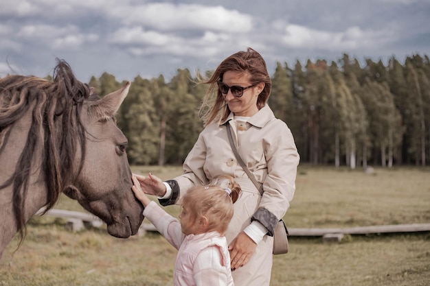 Woman and child with a horse in national park