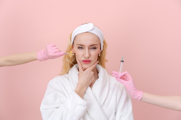 Woman chooses facial care procedure on both sides gloved hands reach out