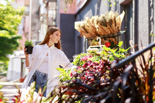 Woman chooses flowers in a florist shop