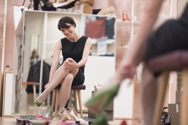 Woman Chooses  Shoes At Fashionable Shop